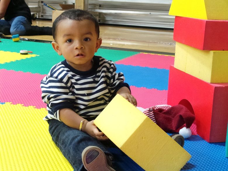photo de bebe craquant qui joue avec des blocs de construction